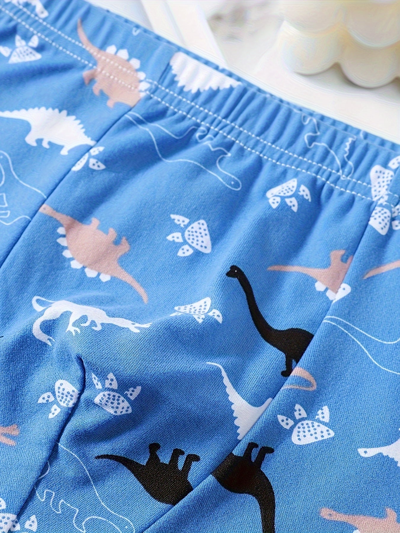 Boys' 3-pack soft cotton blend boxer briefs with cartoon dinosaur patterns. Comfortable and breathable for everyday wear. Casual style with elastic waistband.