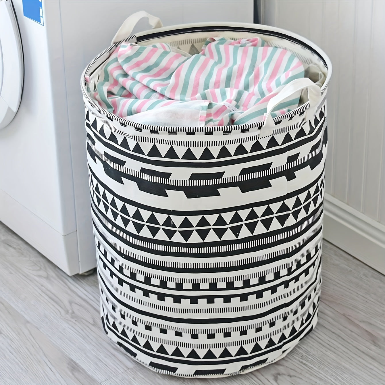 Large capacity fabric hamper for storing dirty clothes and linens, featuring a geometric design. This foldable storage basket can also be used for organizing clothes, dolls, and other items in your bathroom, bedroom, living room, or dorm. A stylish and