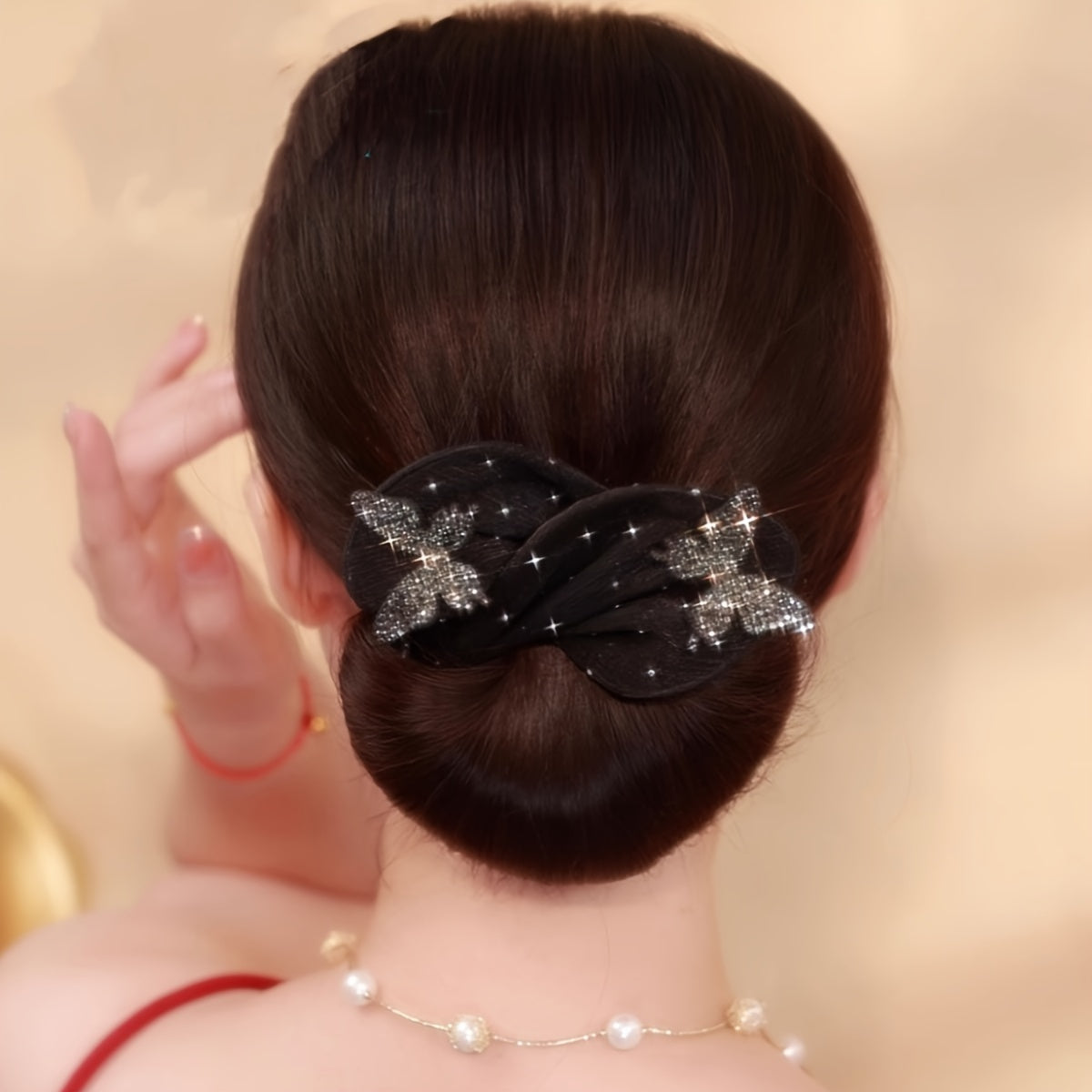 Vintage-inspired hair bun maker with elegant black bowknot design embellished with rhinestones and sequins, suitable for women and girls.