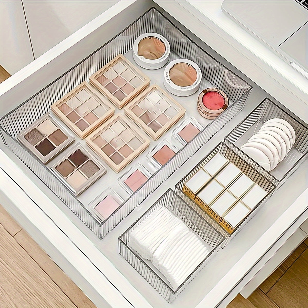 Clear plastic organizer set with customizable drawers for cosmetics and various storage needs, suitable for multiple spaces.