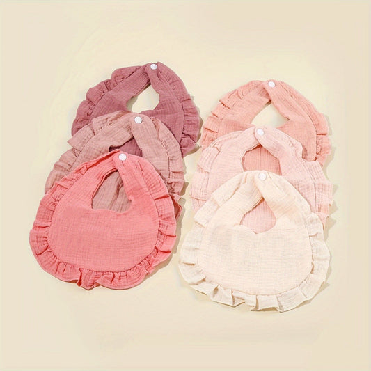 Six pieces of soft, breathable gauze bibs for babies and toddlers with a ruffled hem in multiple colors.