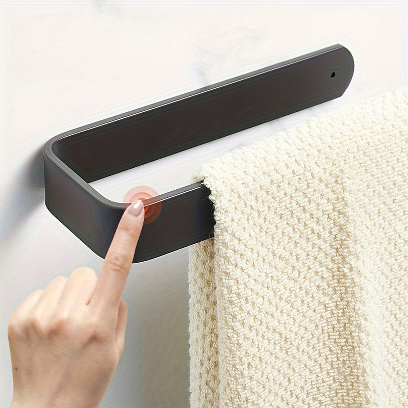 Self-adhesive wall-mounted toilet paper holder for home bathrooms.