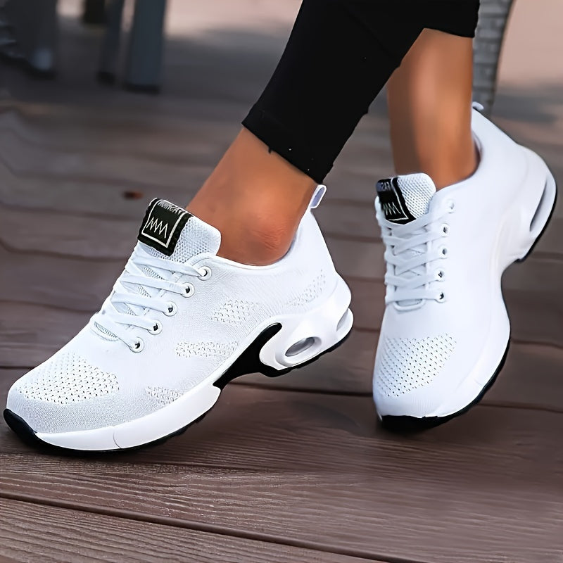 White running shoes for women with breathable knit material, air cushion sole, and shock-absorbing platform design.