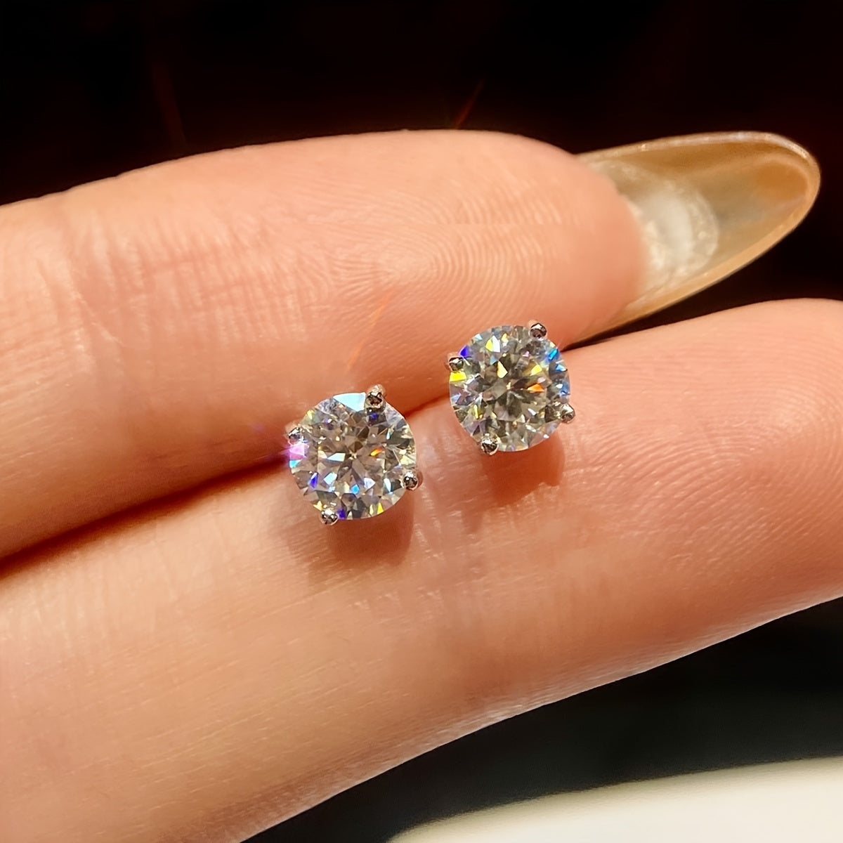 These elegant moissanite earrings come in a pair with a simple four-prong design weighing 1.2 grams for 0.5 carats, 1.7 grams for 1 carat, and 2.5 grams for 2 carats. Perfect for daily wear, these exquisite high-end ladies' jewelry pieces make a stunning