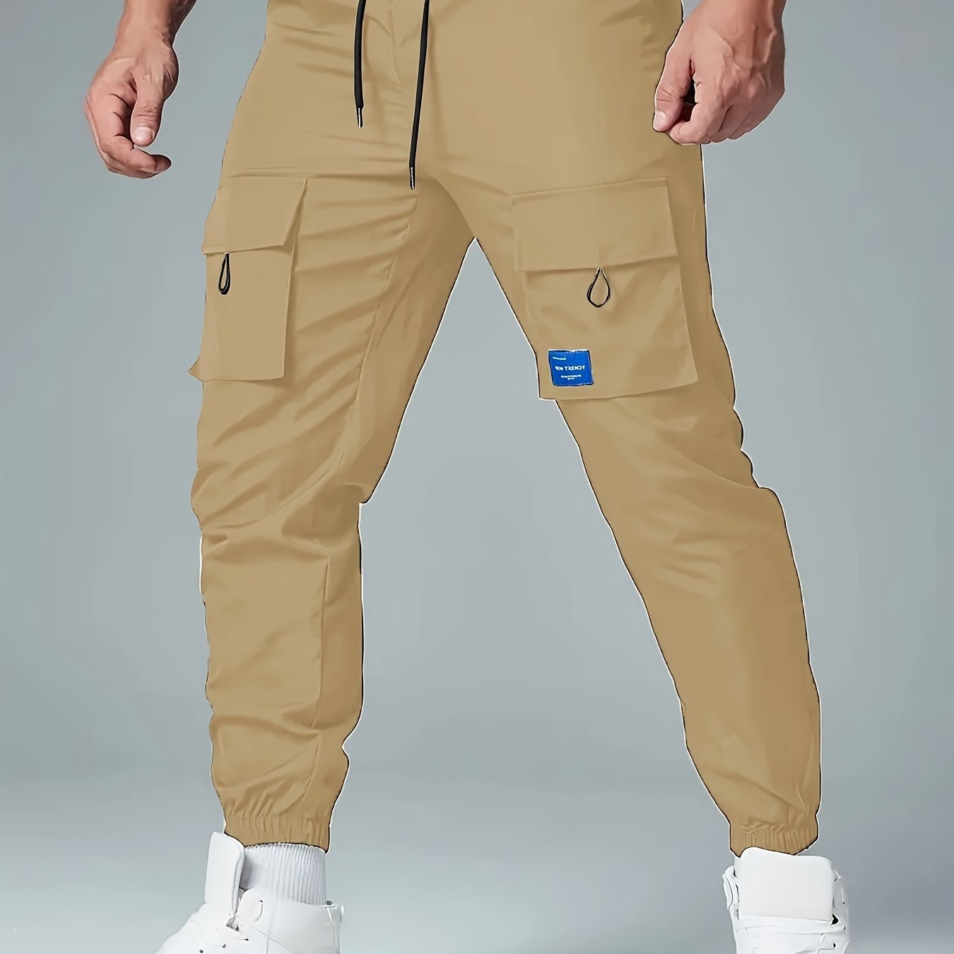 Men's casual drawstring cargo pants with multiple pockets made of polyester, mid-waist, ideal for spring and fall seasons.