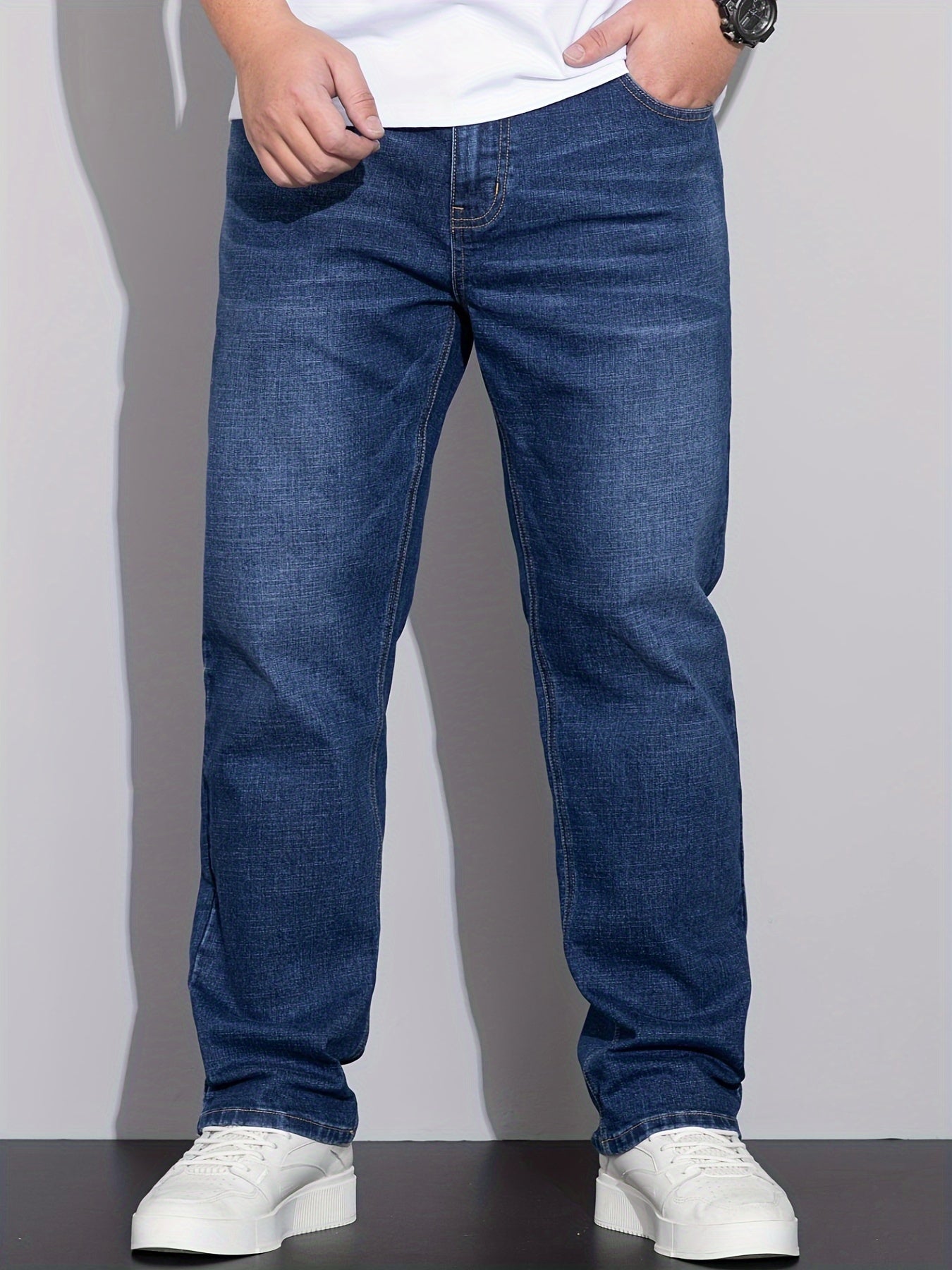 Men's stretchy cotton denim pants for all seasons, in a loose fit and plus size, perfect for business casual wear.