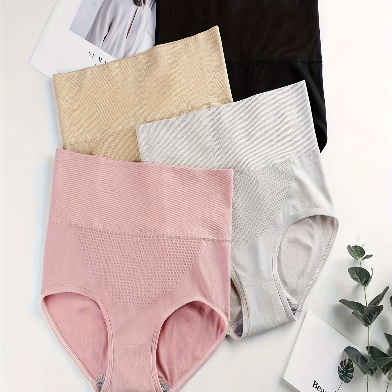 Four pieces of butt-lifting briefs with high waist, tummy control, and breathable fabric, ideal for women's lingerie and underwear.