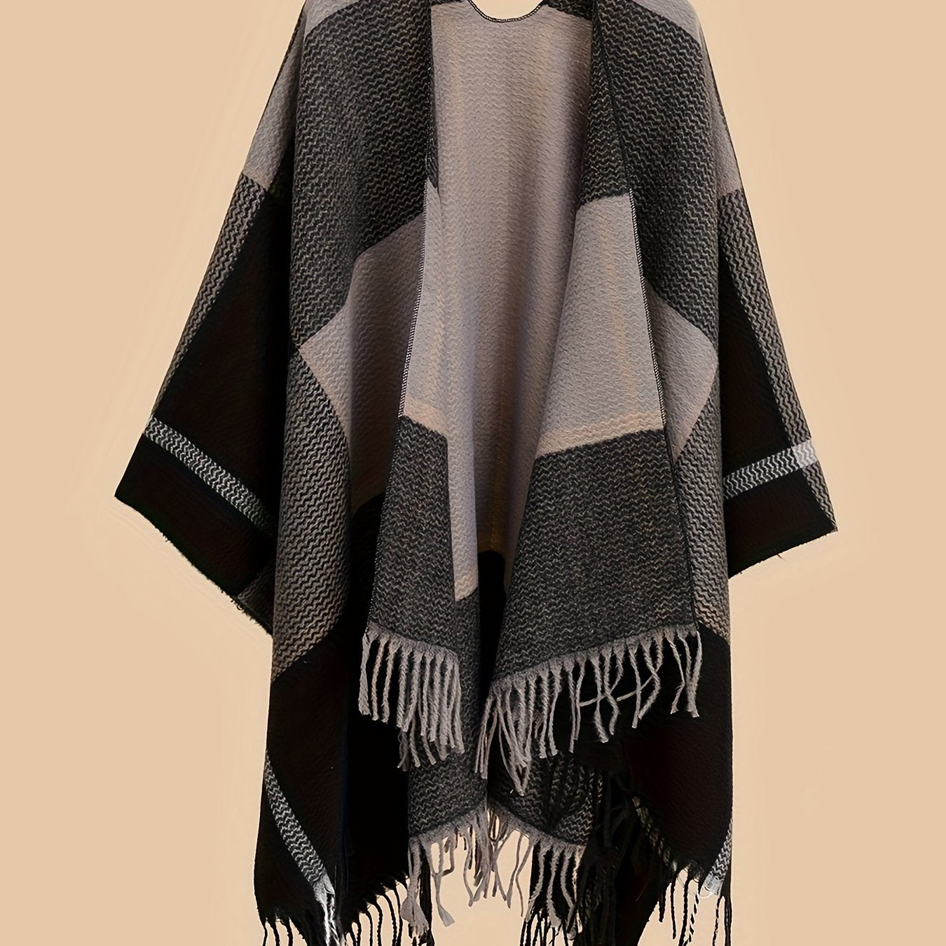 Stylish plus size shawl cardigan with tassels for fall/winter parties features v-neck, asymmetrical hem, and geometric pattern.