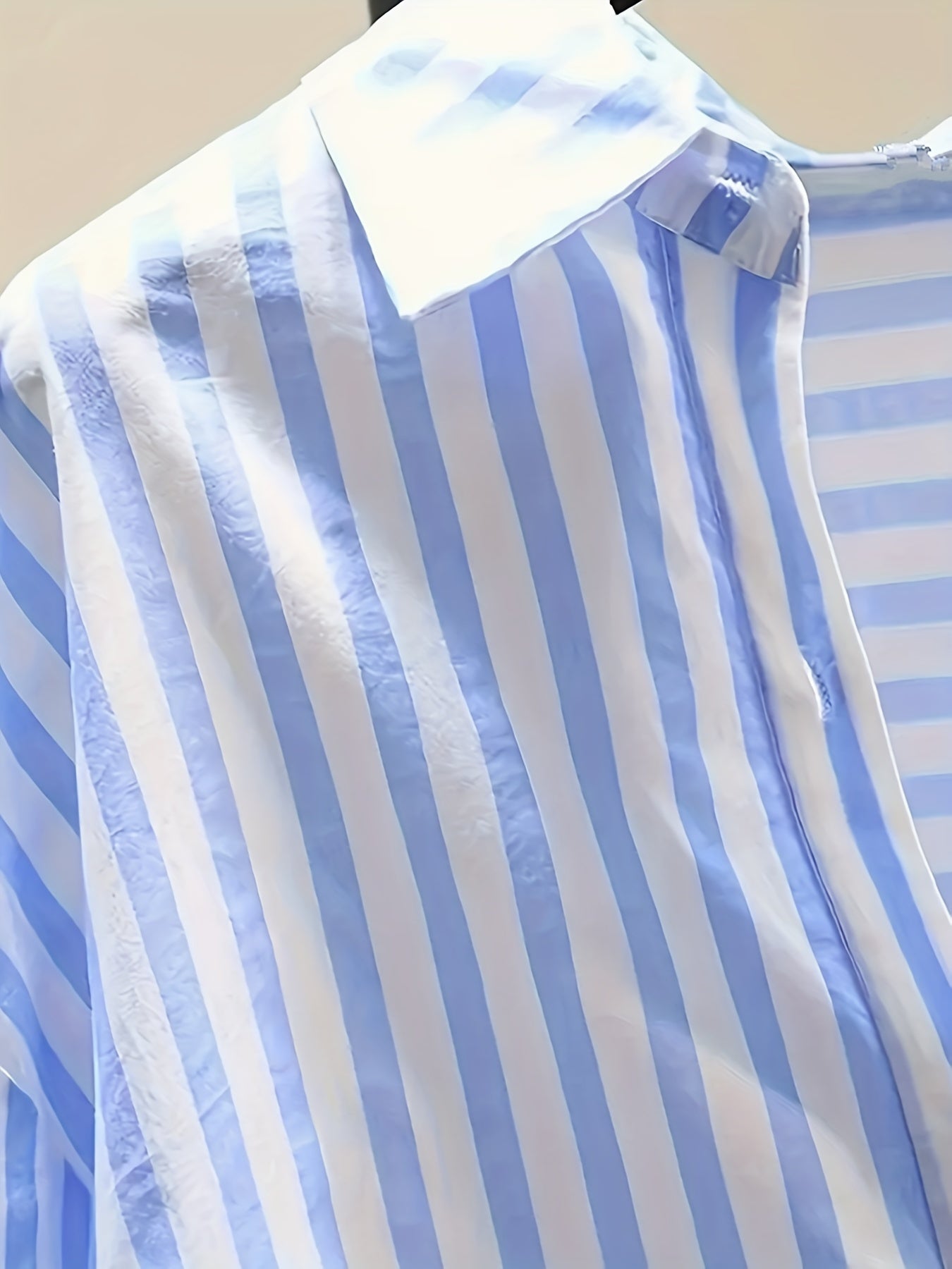 Women's blue and white striped long sleeve button-up shirt with collar, chest pocket. Made of lightweight polyester, machine washable. Suitable for all-season casual or dressy wear.