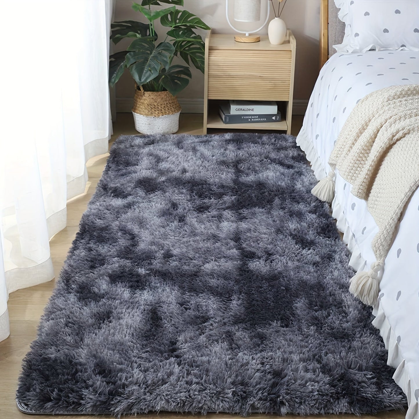 One piece of plush, fluffy area rug designed for bedrooms. This soft, fuzzy shaggy rug is black in color and rectangular in shape, perfect for adding warmth to your living room. It features a non-slip bottom to ensure safety. Great for Halloween or