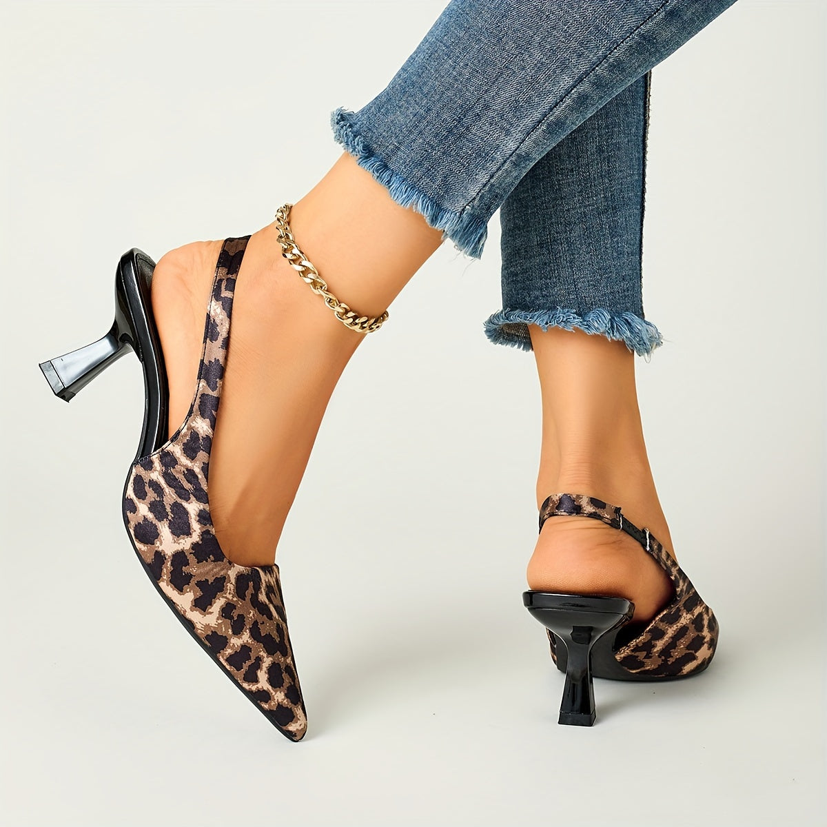 Leopard print stiletto sandals with pointed toe, slip-on style, and high heels in black and brown animal pattern. Comfortable for fall fashion.