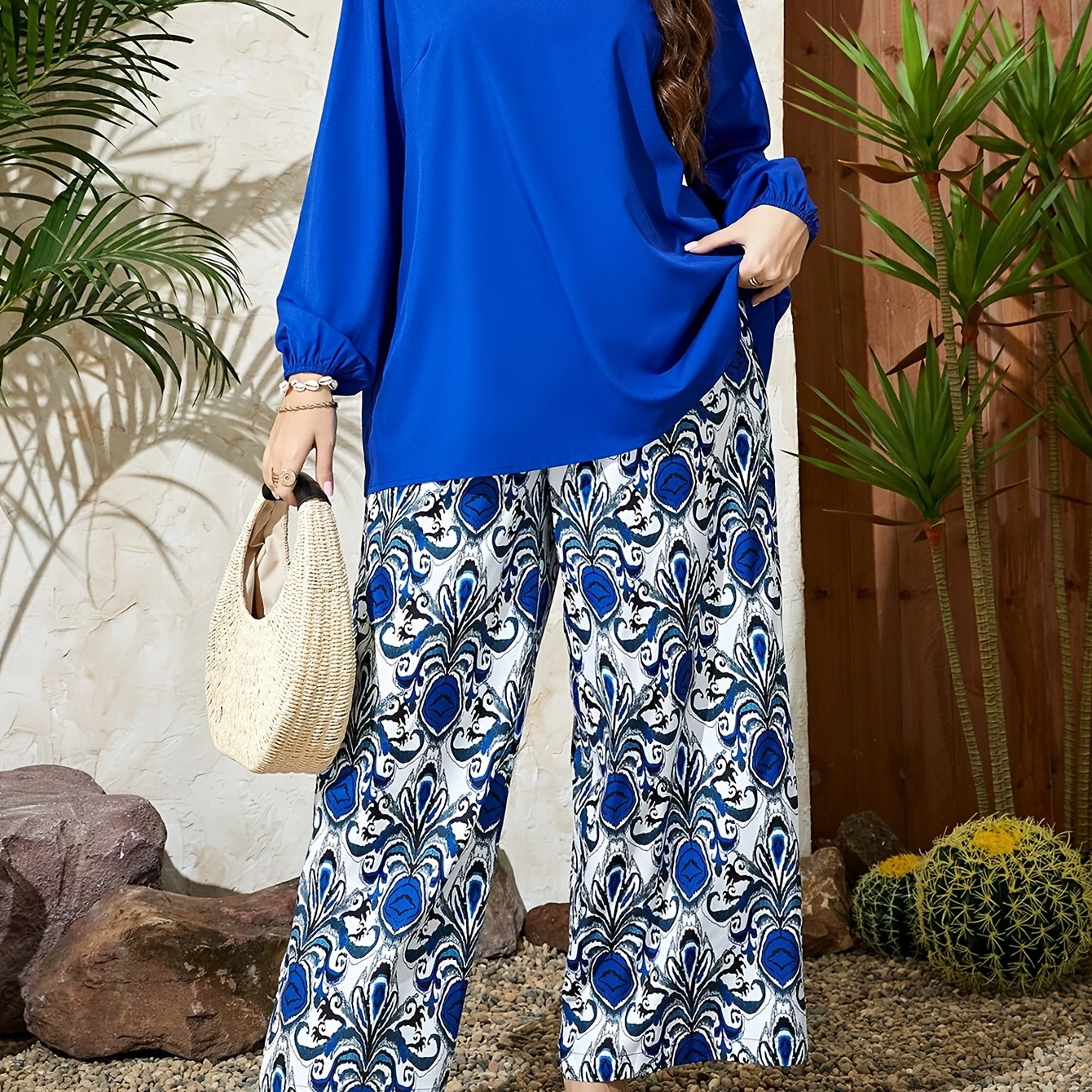 Stylish plus-size outfit: V-neck top and wide-leg pants in blue and white geometric pattern. Made of polyester, machine washable.