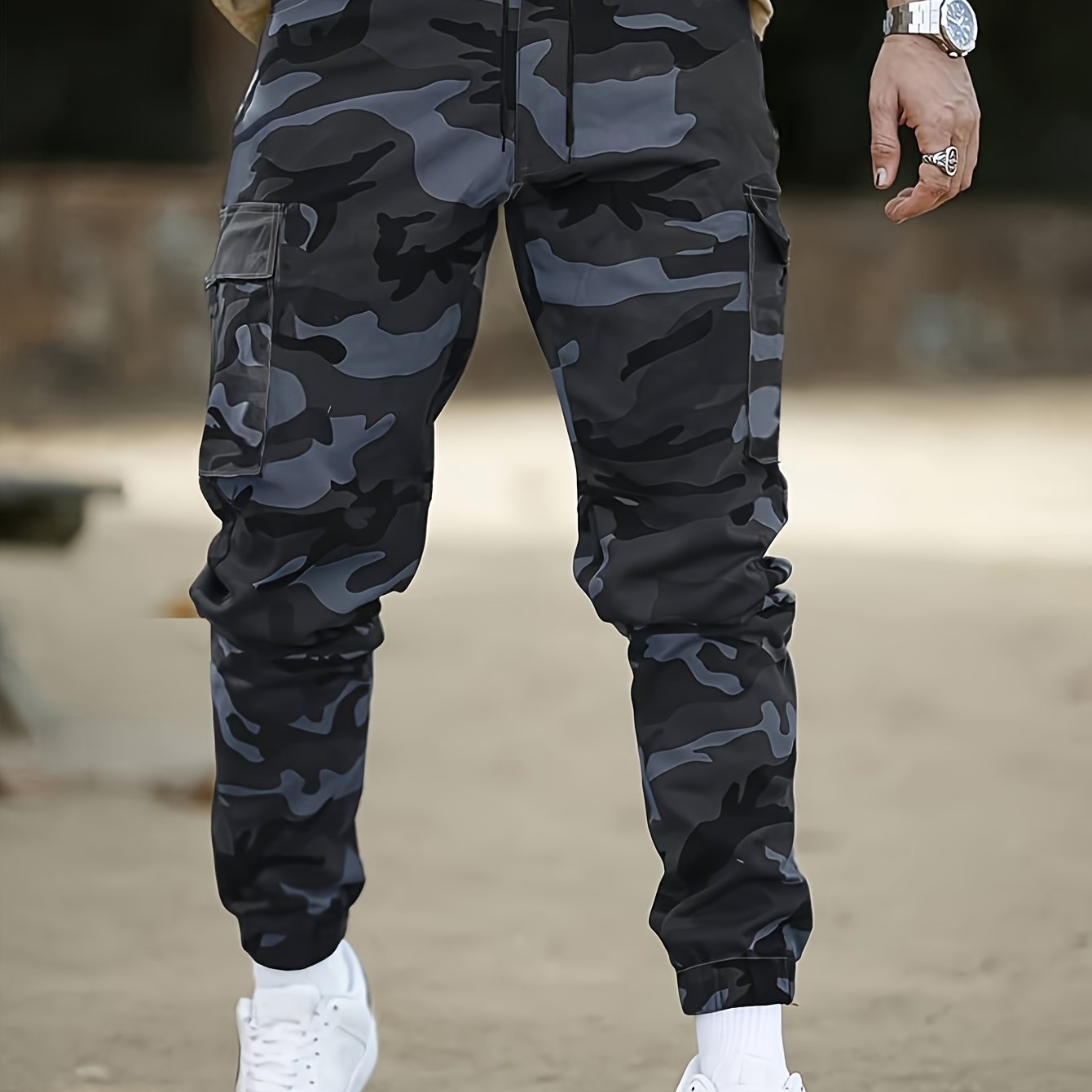 Men's camo cargo pants made from 100% non-stretch polyester fabric with a drawstring waist and flap pockets. Suitable for outdoor work.