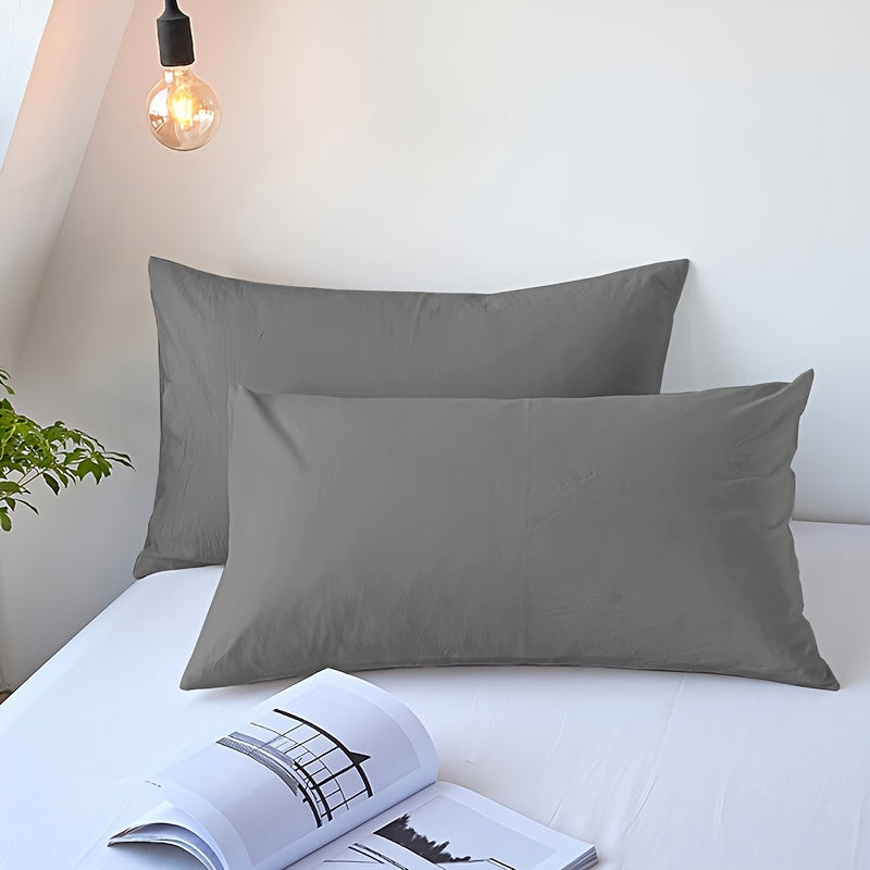 Choose from three different colors - Pure White, Gray, or Navy Blue, with this set of two solid color versatile pillowcases. Made from soft and breathable material with a frosted treatment, these pillowcases are machine washable and come without any