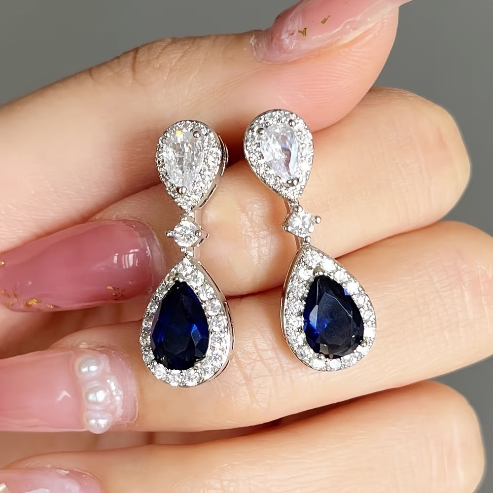 Exquisite and premium jewelry designed for women, showcasing a stunning water drop-shaped silvery earring adorned with shimmering zirconia stones. This elegant piece weighs around 3.9 grams and is ideal for special occasions and evening gatherings. A