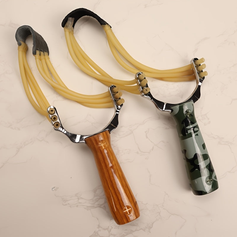 One alloy slingshot with plastic handle in camouflage design, ideal for outdoor shooting with wooden texture and three rubber bands.