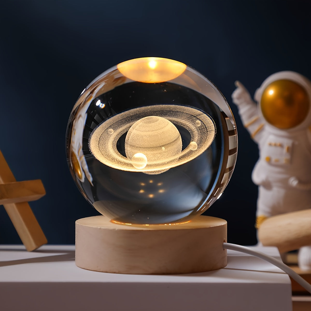 One 3D laser engraved crystal ball night light featuring the solar system and Saturn, powered by USB for home and office decoration, and makes a special gift for Valentine's Day, Christmas, or birthdays.