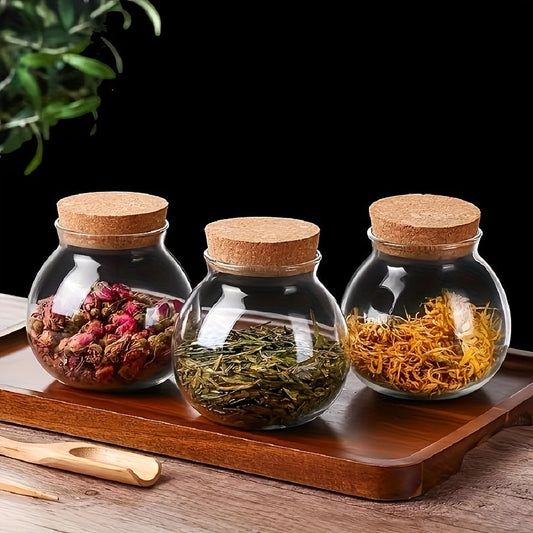 This glass storage jar with cork lid holds 16.9oz and is perfect for storing various items in your kitchen. Made of BPA-free and heat-resistant materials, it is a versatile canister that can be used for storing coffee beans, tea, flour, sugar, and more.