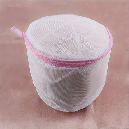 Sturdy polyester mesh laundry bag for delicates with fine grid, pink zipper. Hand washable, prevents deformation in washing machine. Breathable mesh design, laundry room essential.