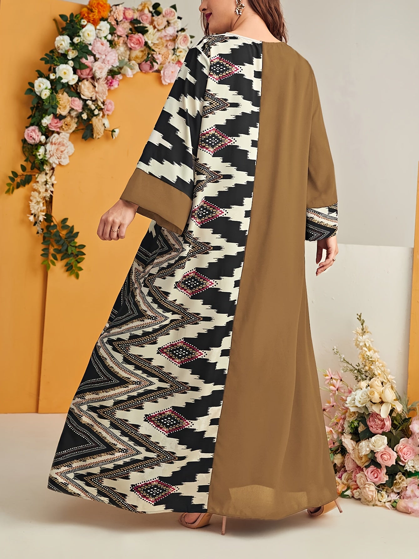 Elegant plus size geometric kaftan dress in black and beige houndstooth pattern with floral accents. Made of polyester, machine washable, with V-neck, long sleeves, and flowing silhouette