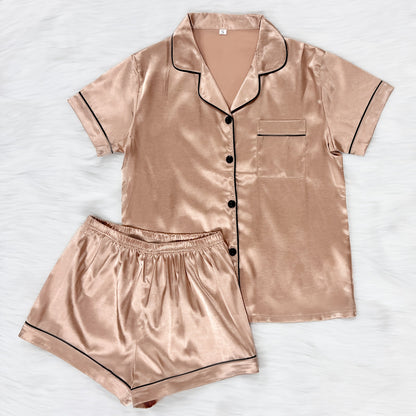 Casual satin pajama set for women with short sleeve top, lapel buttons, and shorts for a comfortable fit.