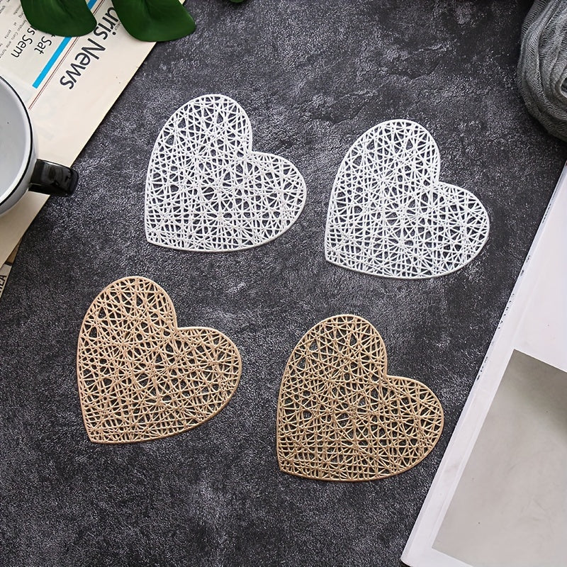 Set of 4 heart-shaped placemats and coasters made of PVC with heat insulation and non-slip features, ideal for household decoration and meal protection on dining tables.