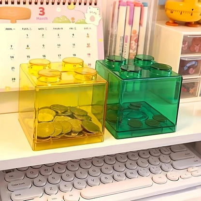 Clear plastic coin bank for saving coins at home.