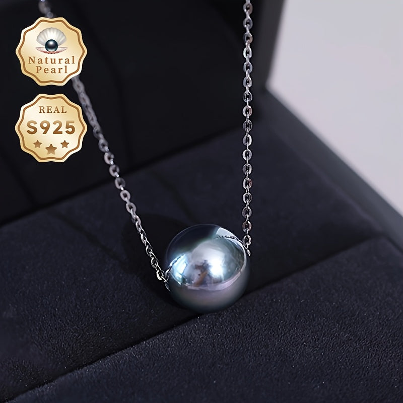 This necklace features a stunning large grain round Tahitian black pearl pendant suspended on a S925 silver chain. Each pearl is unique, so the color and shape may vary. This simple yet elegant piece is perfect for any woman's fashion collection and