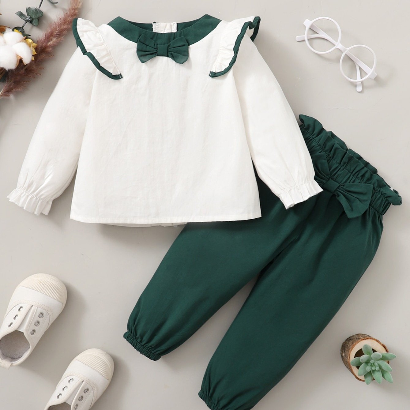 Two-piece set with lace trim top and pants for girls.