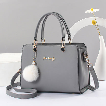 Women's stylish faux leather handbag with tassel embellishment, adjustable strap, zipper closure, and polyester lining. Available in multiple colors.