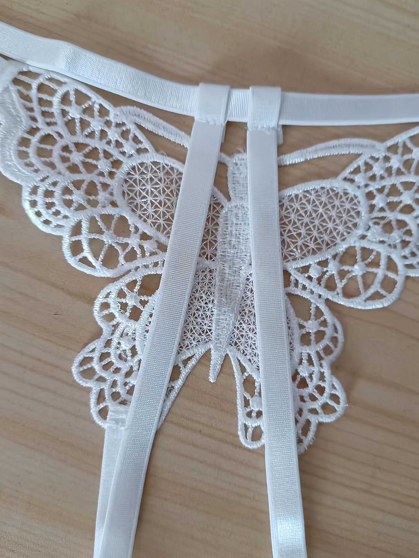 Sexy butterfly pattern panties with open crotch and low waist for women.