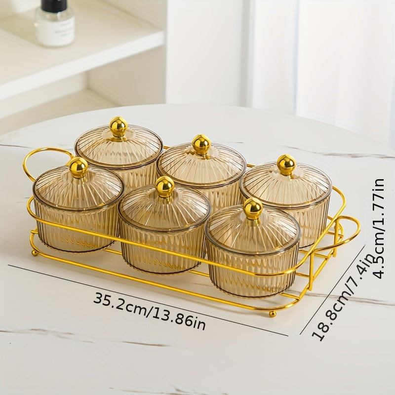 Luxurious snack serving set with lid-covered plastic dishes on a golden tray, perfect for displaying dried fruits and candies on a living room coffee table.