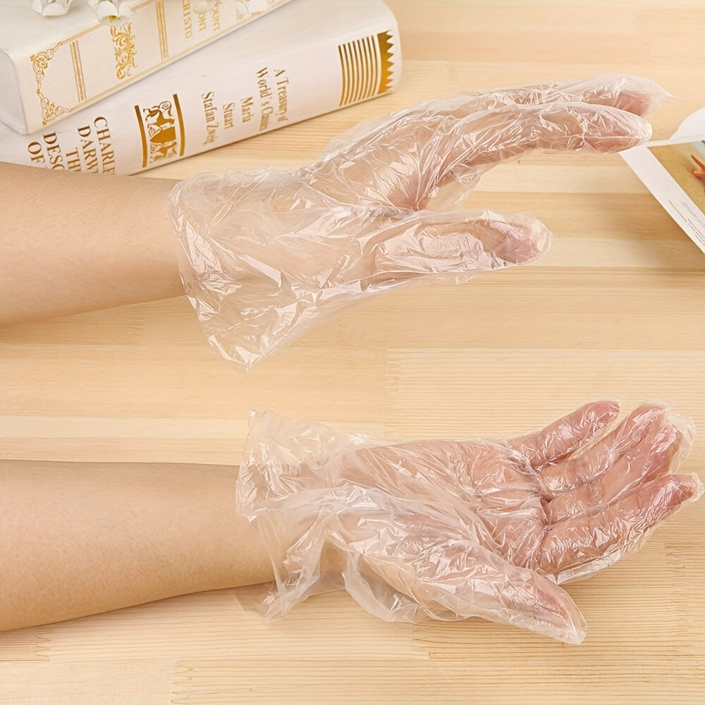 Disposable plastic BBQ gloves in a set of 90-100 pieces, transparent and designed to protect your hands while handling food for healthier cooking.