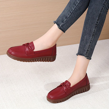 Women's comfortable penny loafers with bow embellishment, non-slip sole, round toe, all-season footwear, man-made materials, TPR sole.