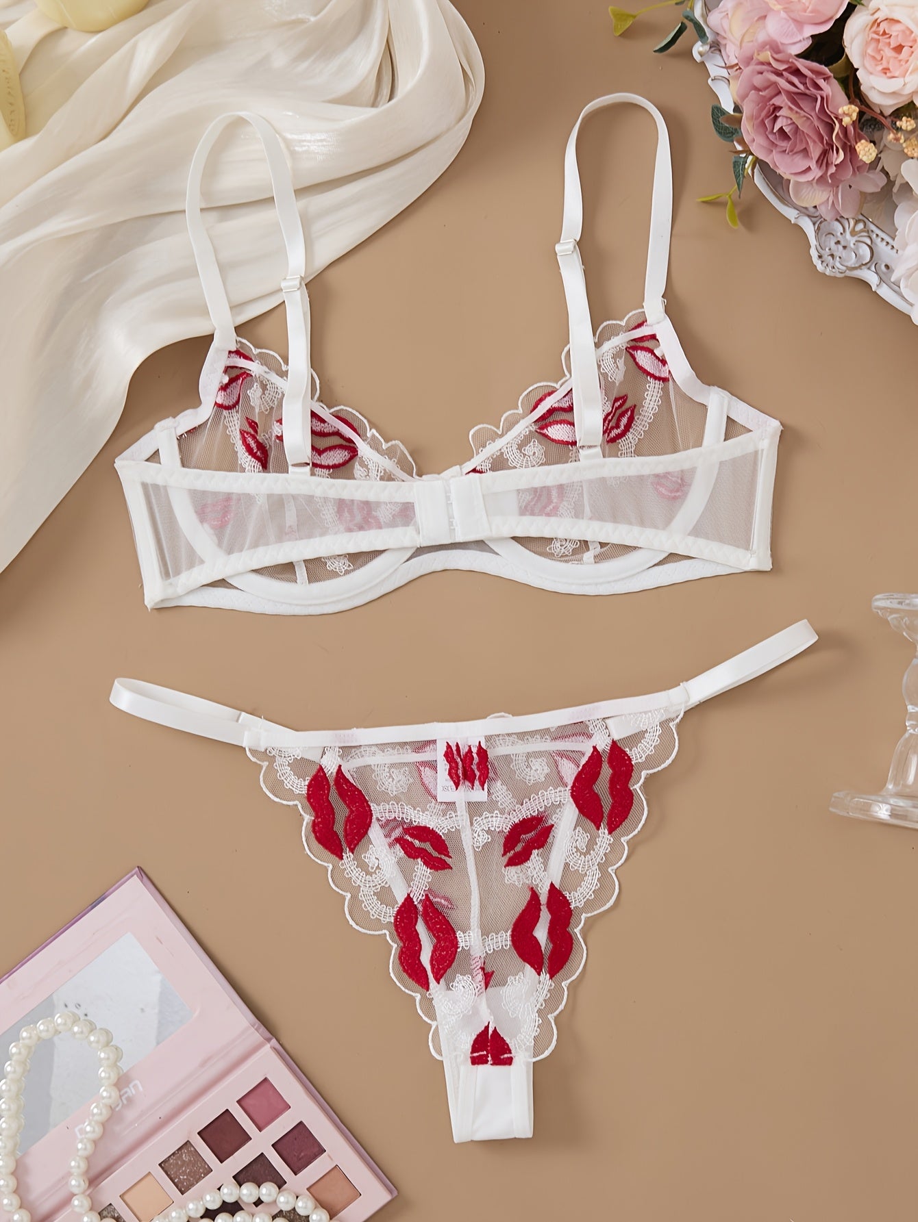 Valentine's Day lingerie set for women featuring embroidered sheer mesh bra and adjustable thong, made from mature style polyester knit fabric with medium support and no padding. Designed