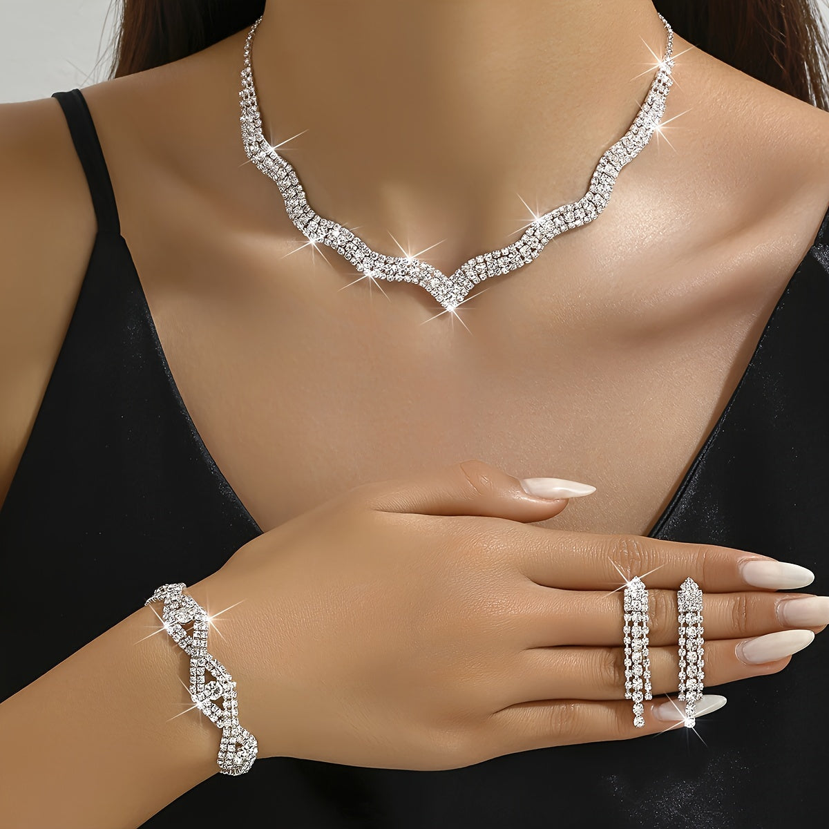 This elegant white jewelry set includes a stunning necklace, a pair of exquisite earrings, and a delicate bracelet, making it the perfect accessory for wedding parties and bridal gowns.