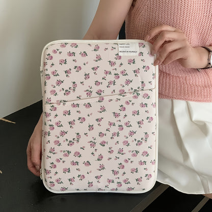 Pink floral laptop sleeve for 25.4-35.56 cm tablets and laptops made of kawaii polyester with pastel flower design. Ideal for office or school use. Laptop accessory with kawaii design and