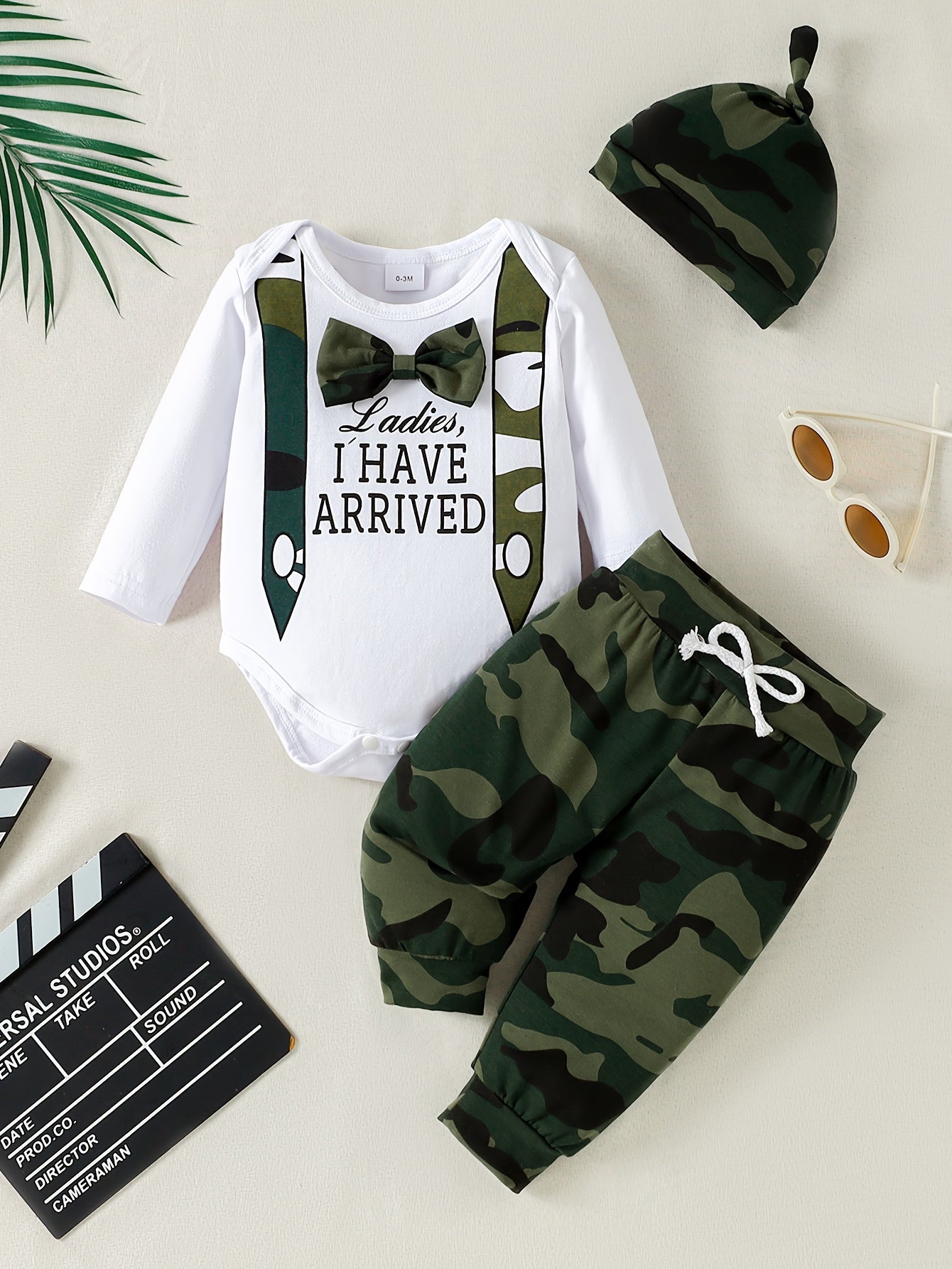 Three-piece set for stylish boys and babies includes a camouflage bow long-sleeved shirt, pants, and hat.