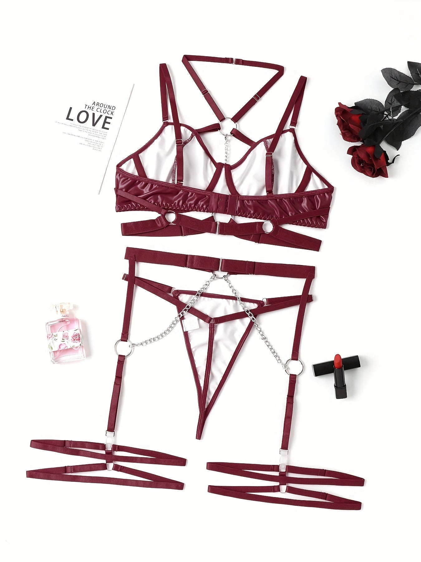 Women's punk lingerie set with ring-link strappy design, halter plunge bra, garter belt, and thong.