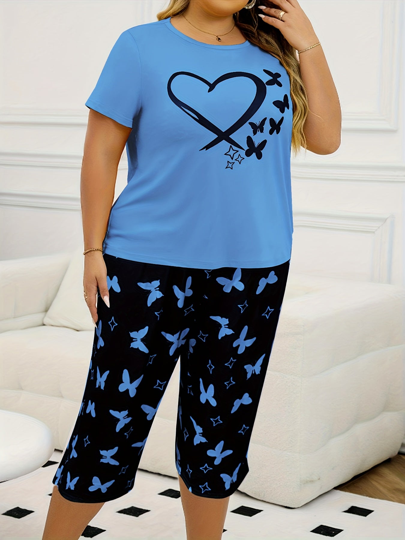 Women's casual butterfly print short sleeve t-shirt and capri pants pajama set made from polyester knit fabric with slight stretch for all-season comfort. 95% polyester, 5% elastane.