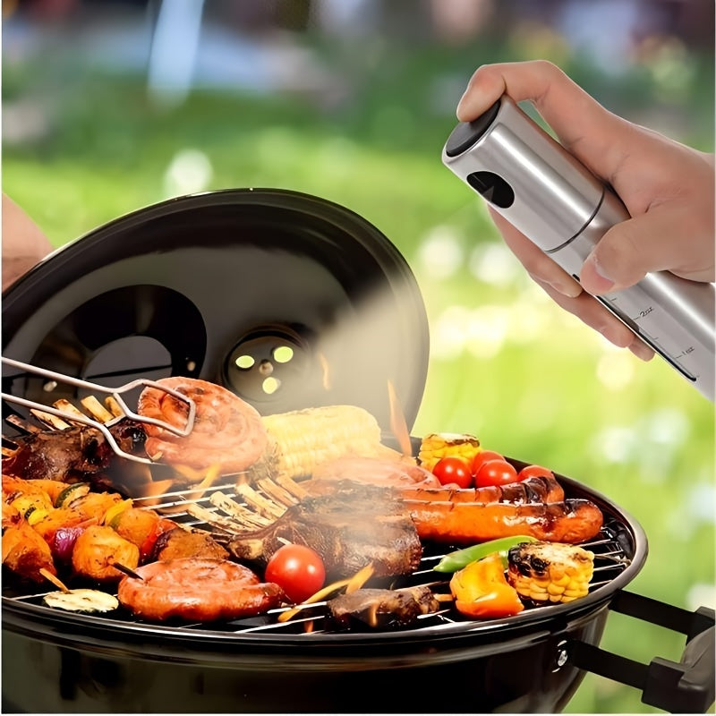 A 100ml stainless steel oil spray bottle for household kitchen use, perfect for seasoning and barbecuing with olive oil.