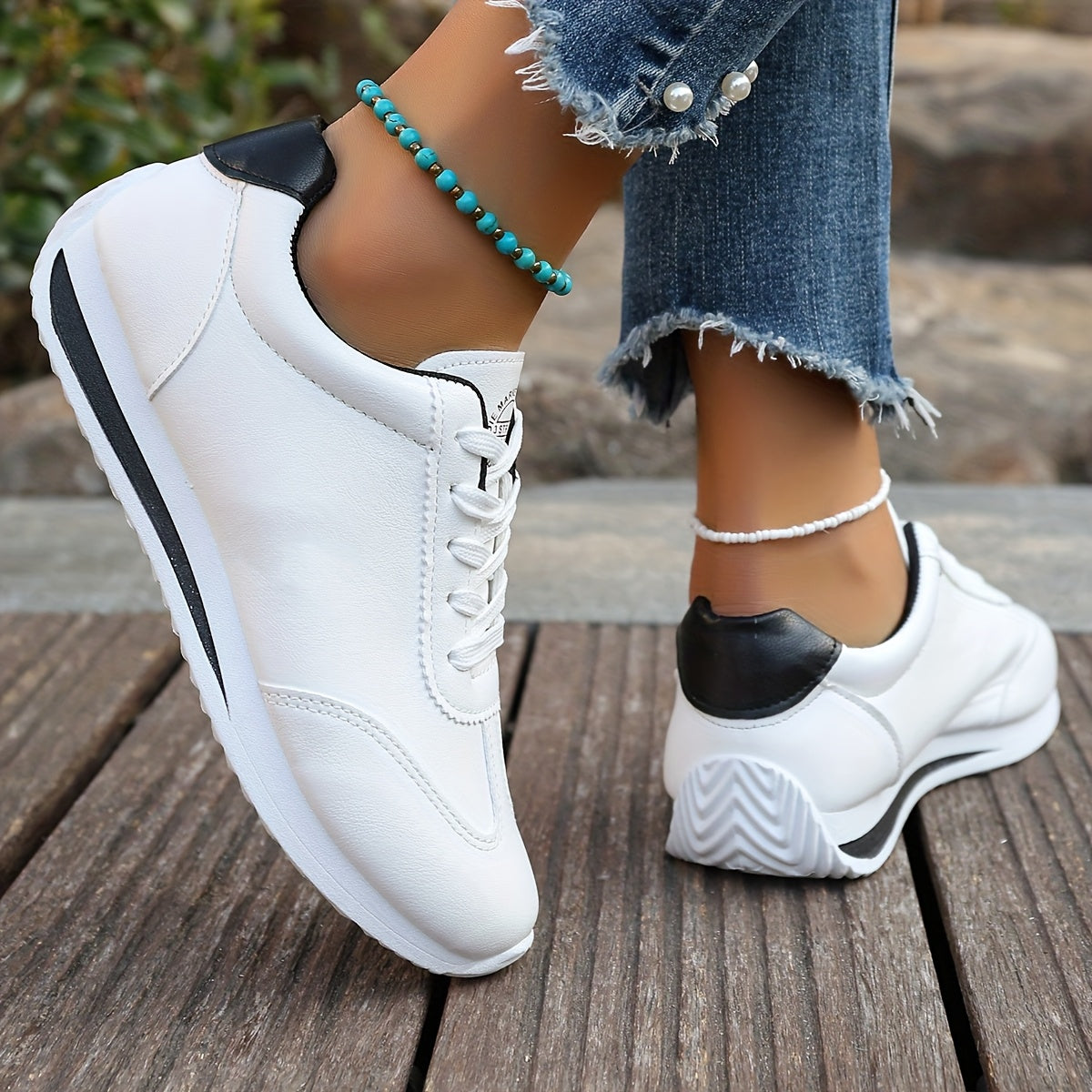 White synthetic leather women's casual sneakers with stability support, all-season comfort, and breathable fabric lining. Perfect for casual attire.