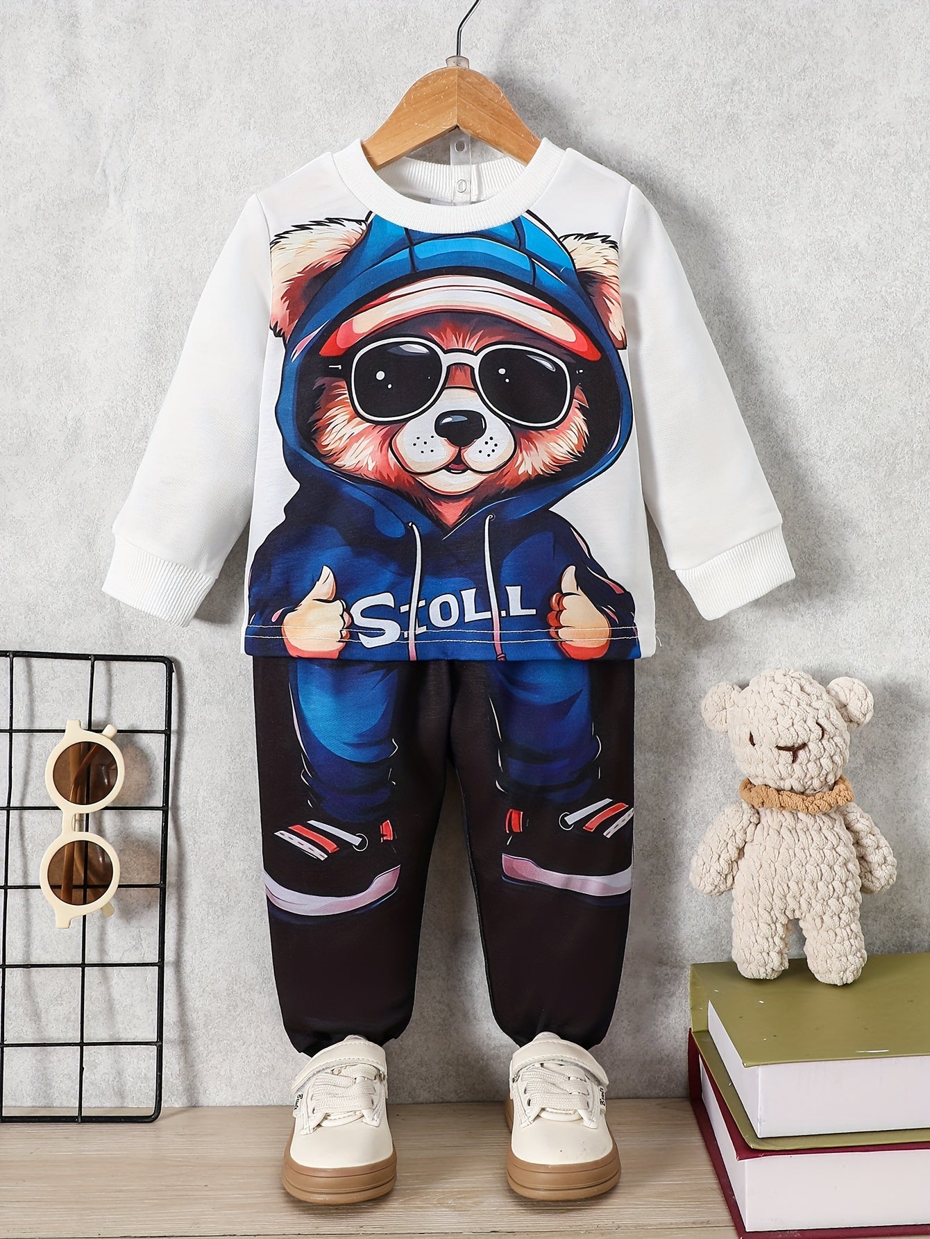 Newborn boy's trendy sweatshirt and pants set with hooded bear print, ideal for fall and winter.