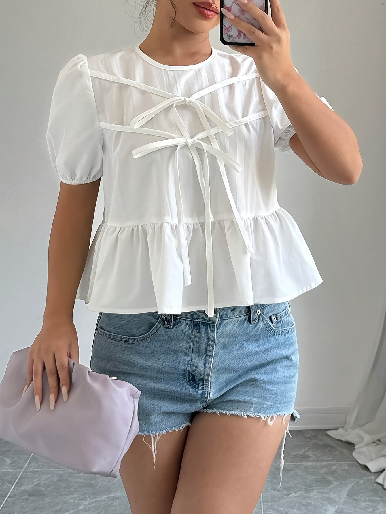 Puff-sleeve shirt with ruffles and front bow tie.