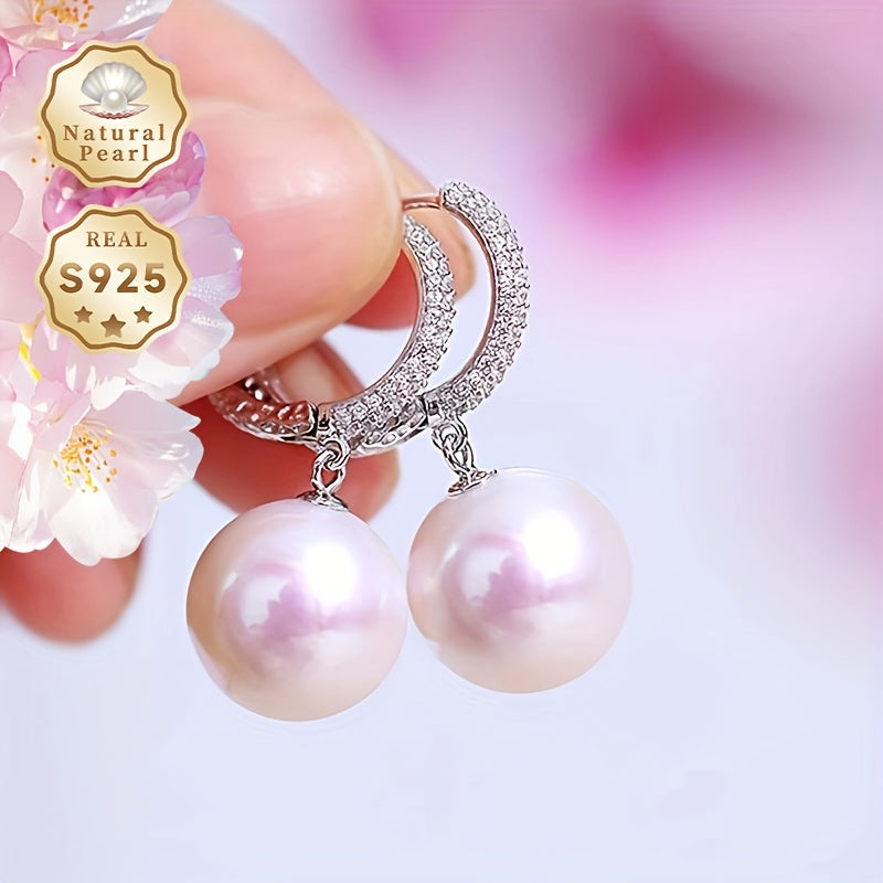 Get ready to dazzle with the luxurious elegance of these Daimi Hoop Earrings, made with 925 Sterling Silver and adorned with a natural Freshwater Pearl, the perfect June Birthstone gift for any occasion