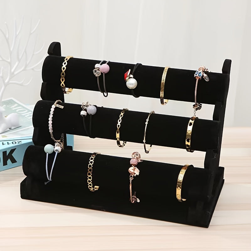 Elegant 3-tier velvet jewelry display stand with wooden base, white marble and black rollers. Multi-level organizer for bracelets, watches, and home decor. Perfect for showcasing in stores or at home. Features elegant design with marble texture.