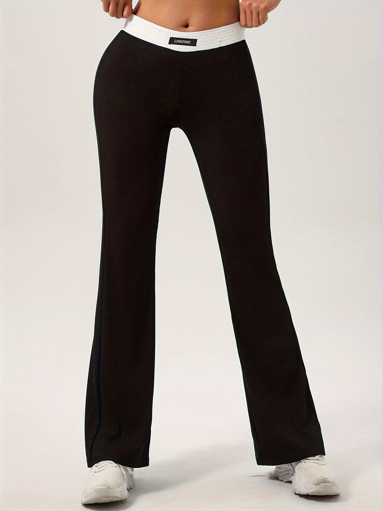 High-waisted slimming flare pants with contrasting color detail, comfortable fit, and stretch fabric for casual fall wear.