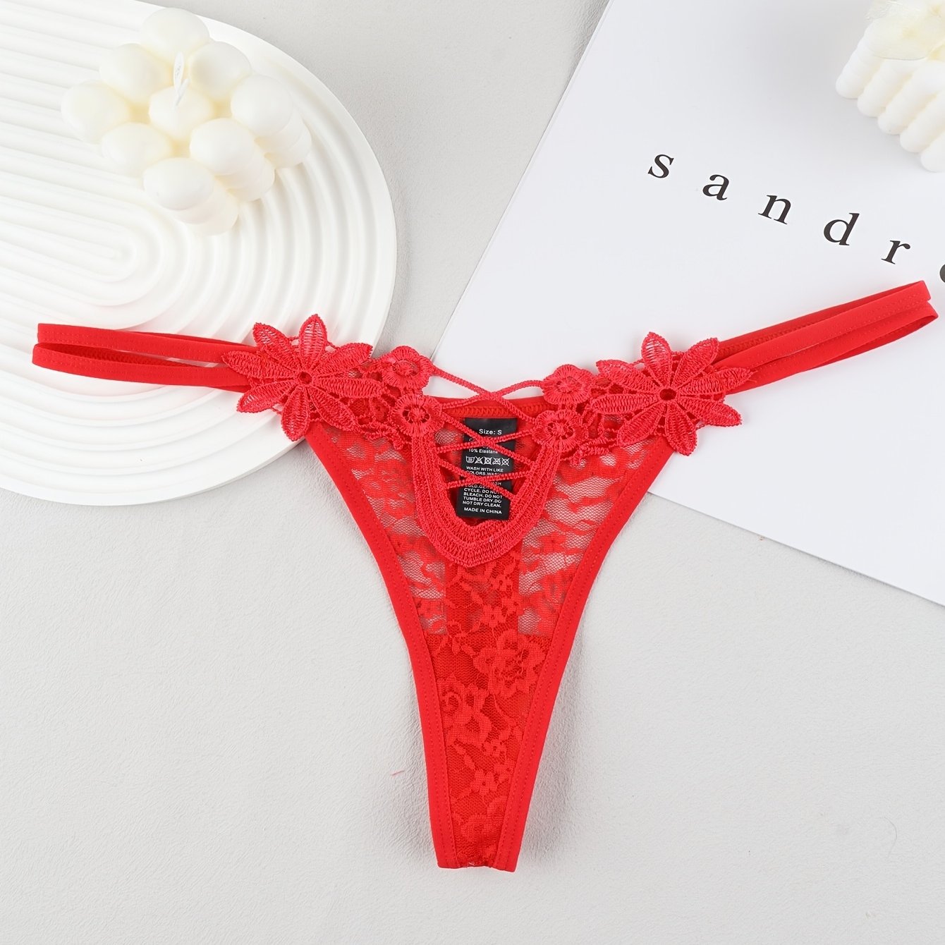 Red lace thong with mesh detail, made of 90% polyamide and 10% elastane, perfect for adults.