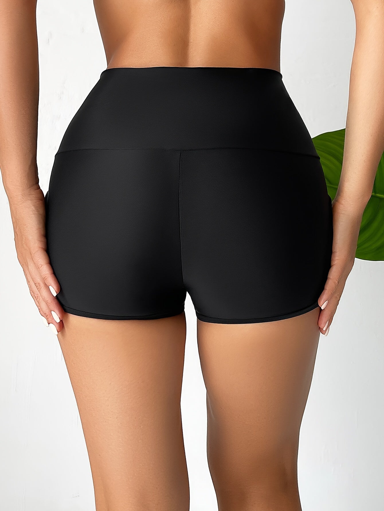 Women's high waist black boxer shorts with cut-out sides, perfect for beachwear.