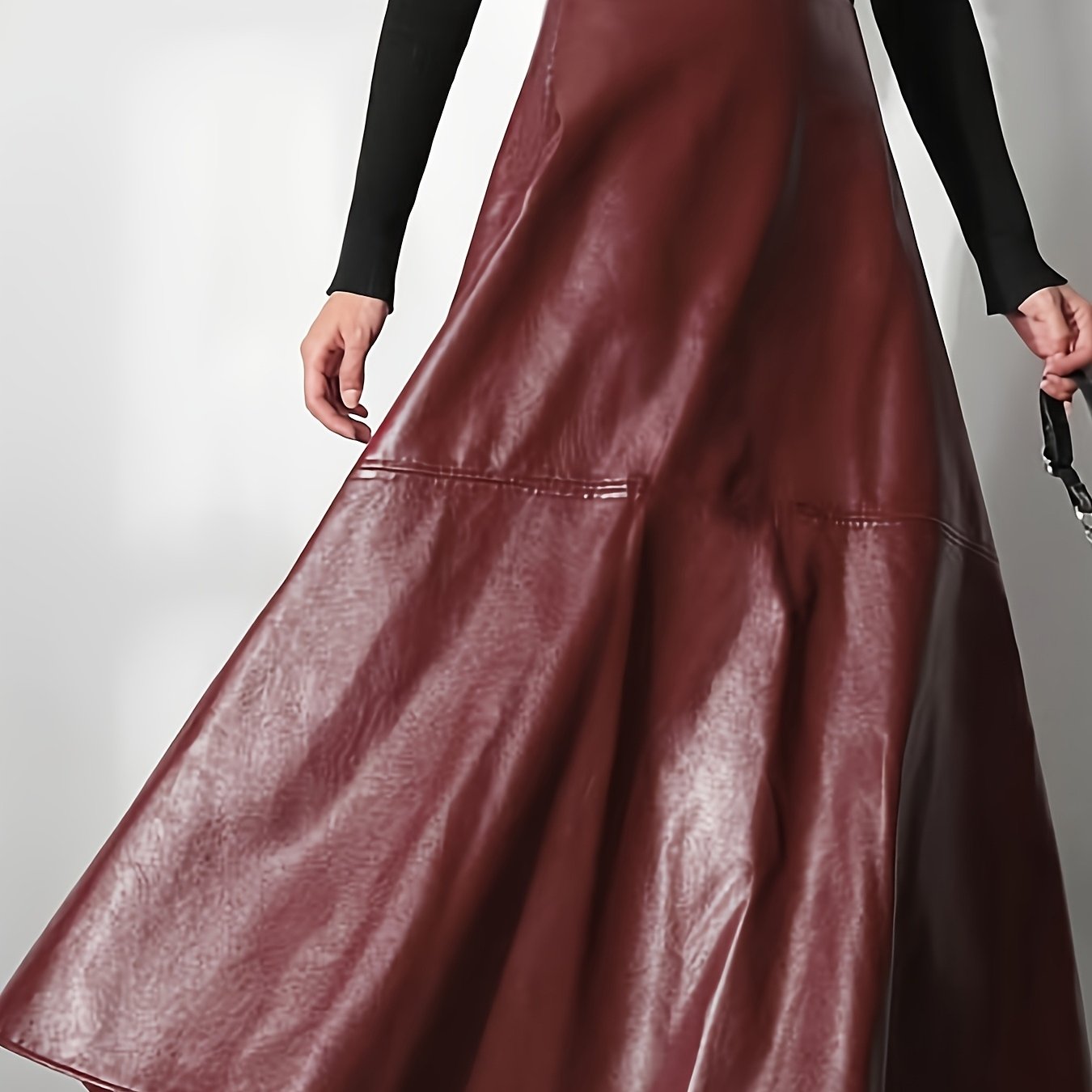 Plus-size fashionable women's flared A-line faux leather skirt with custom design.